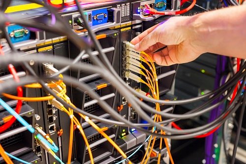 hand plugging fiber cable into switch in datacente 2022 10 07 03 36 26 utc